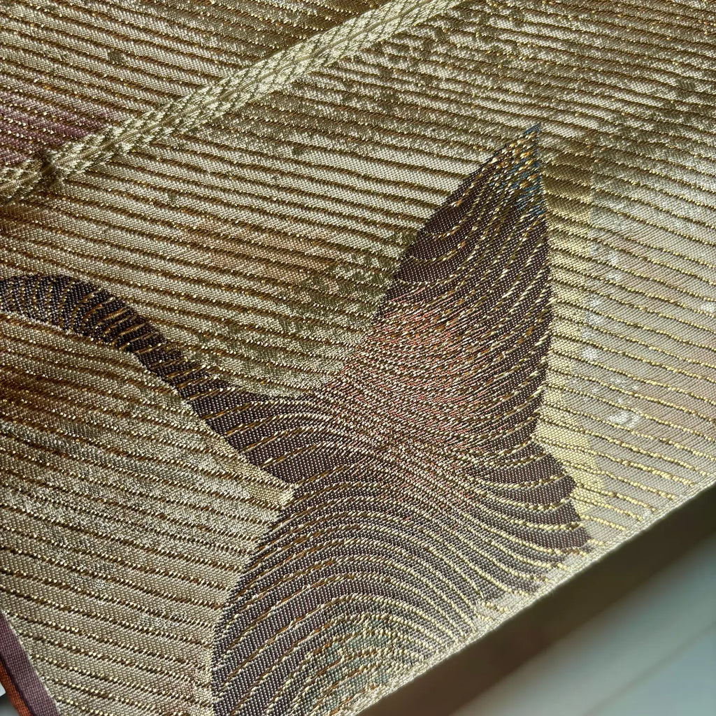 Close-up of a textured fabric with a bird design on a neutral background