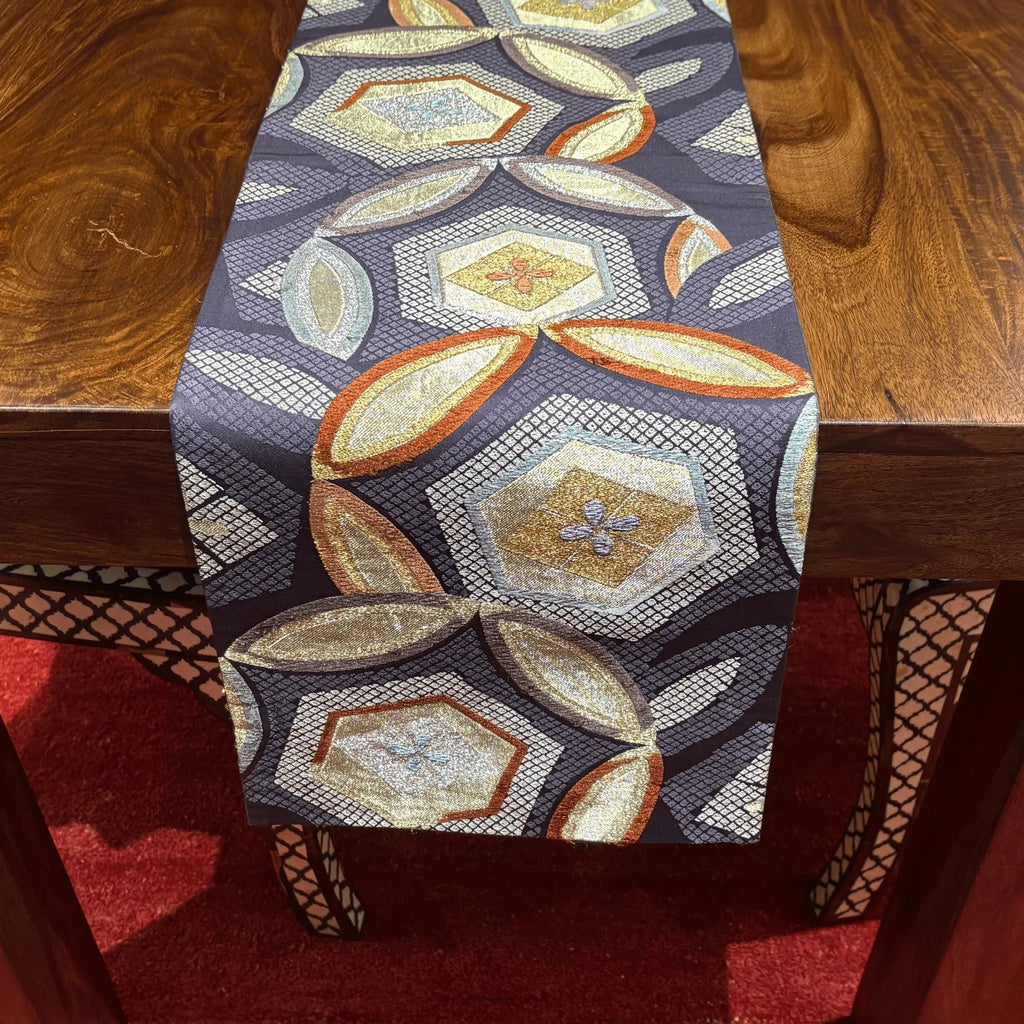 Decorative table runner with geometric pattern on a wooden table