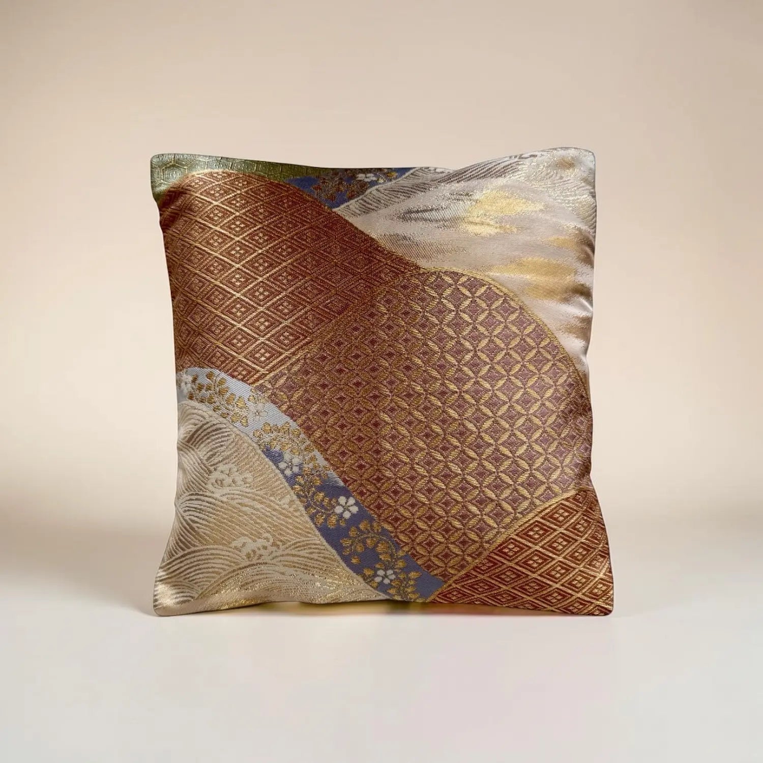 Decorative cushion with gold and brown pattern on a beige background
