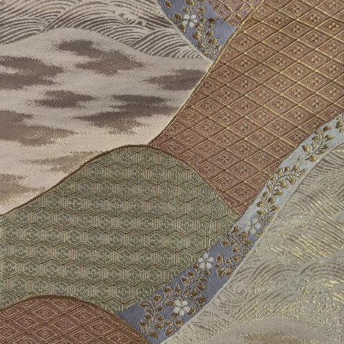 Close-up of a fabric with intricate patterns in brown, beige, and blue.