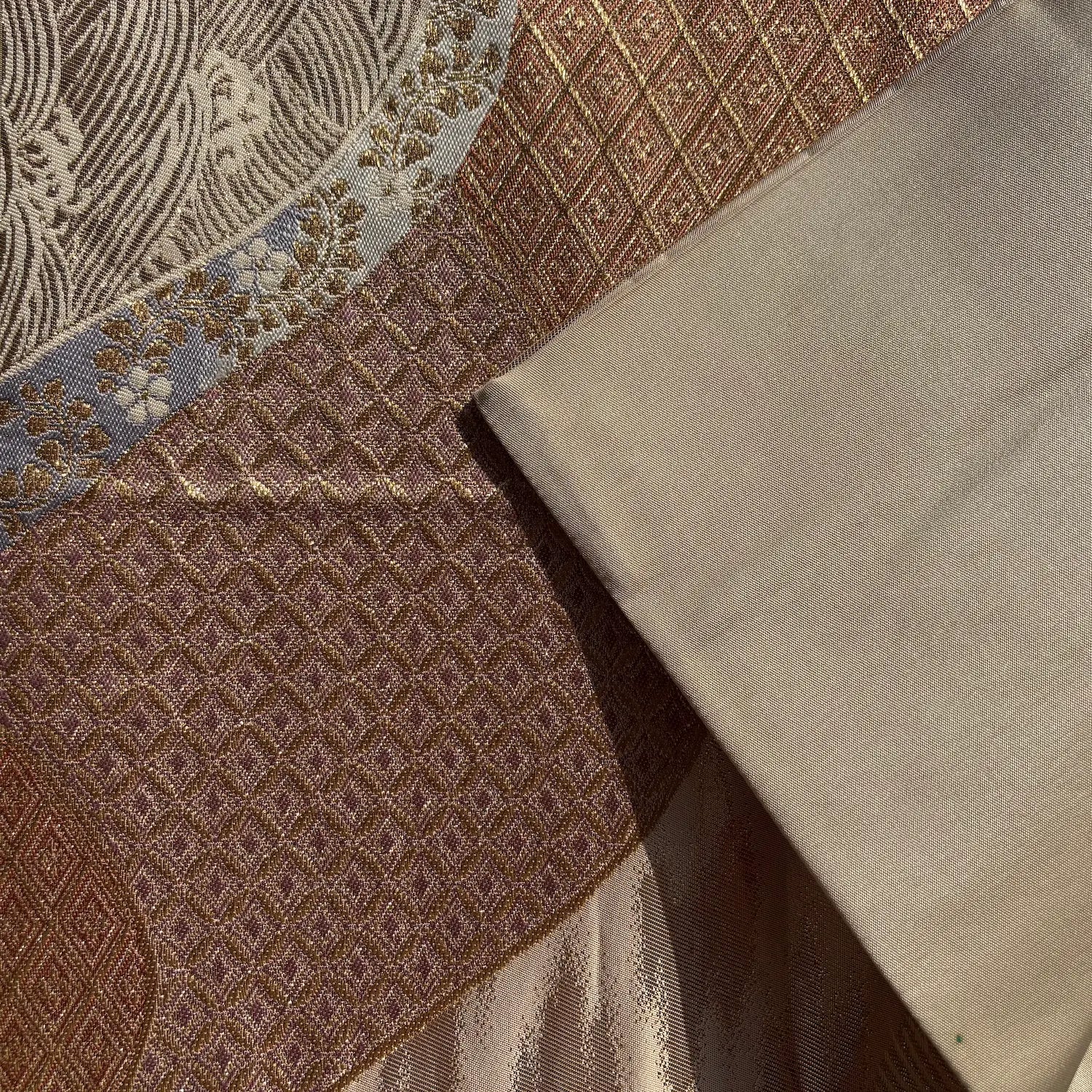 Close-up of textured fabric with geometric patterns in brown and beige tones.
