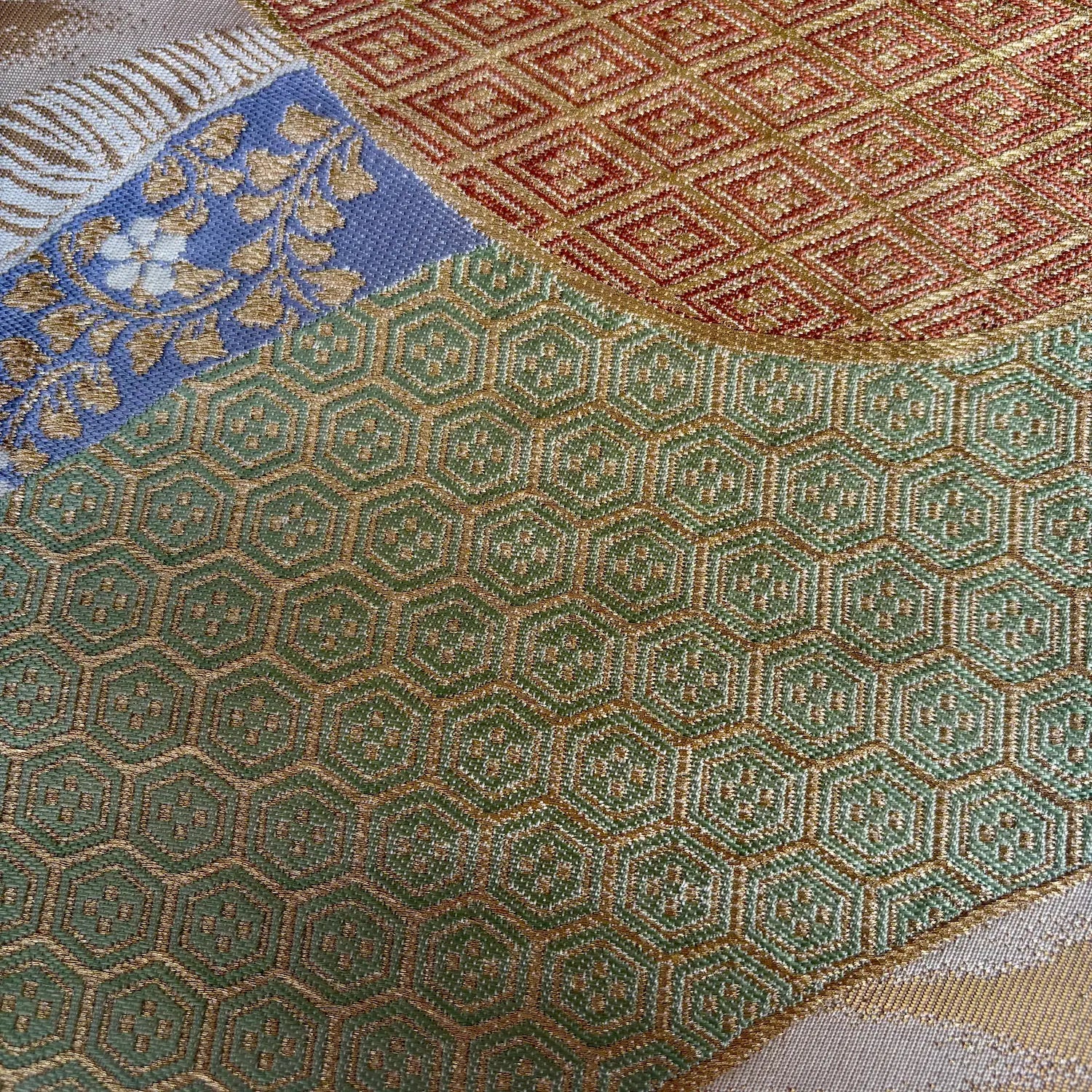 Close-up of various textured fabric patterns including floral, geometric, and hexagonal designs.