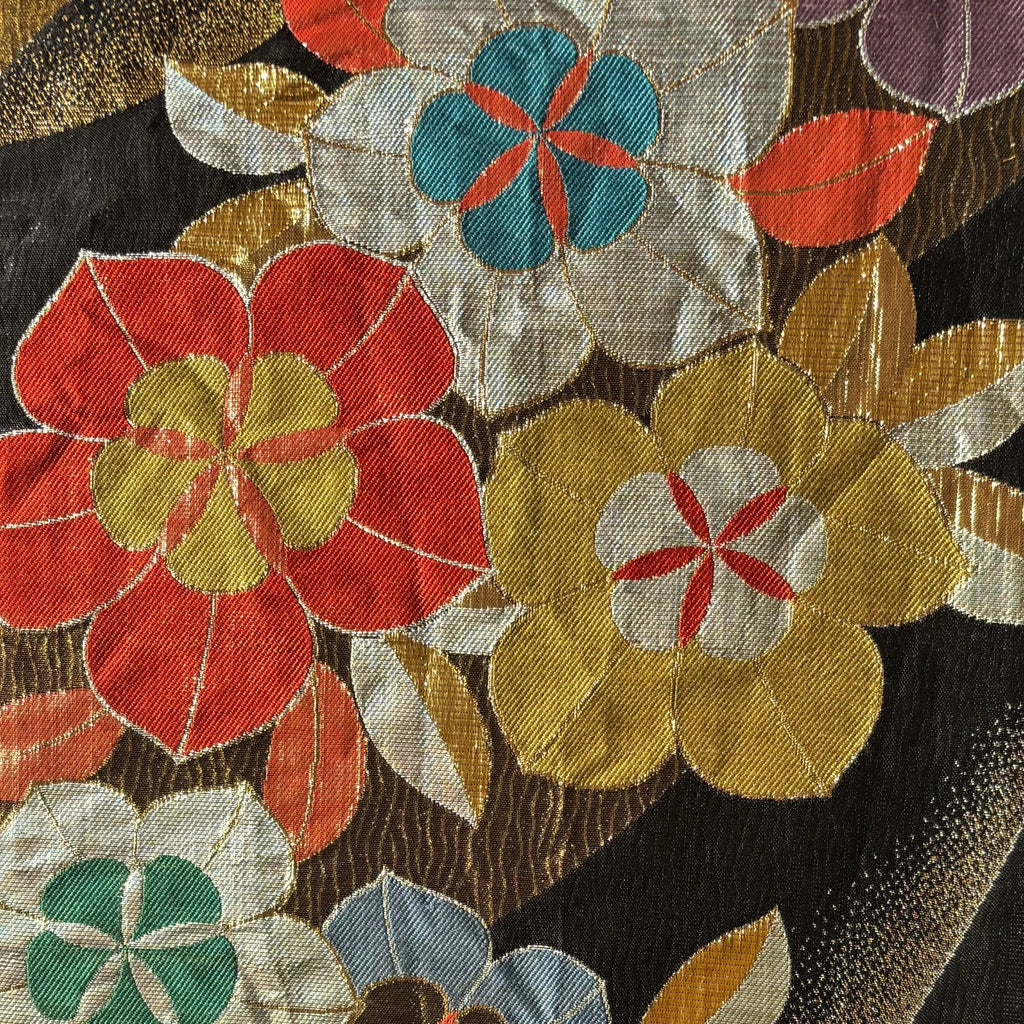 Close-up of a silk Obi with colorful floral patterns