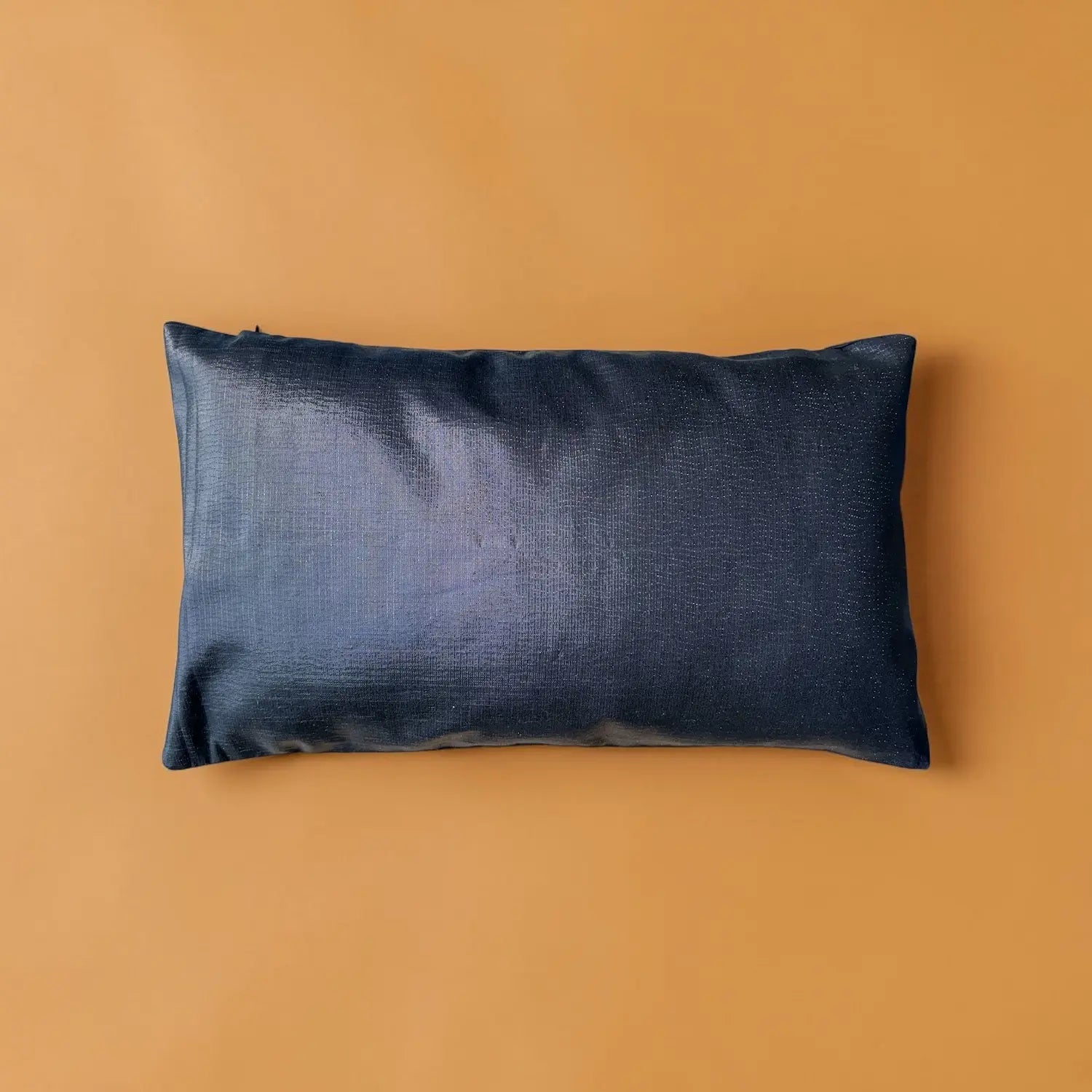 Navy blue pillow on a mustard yellow background