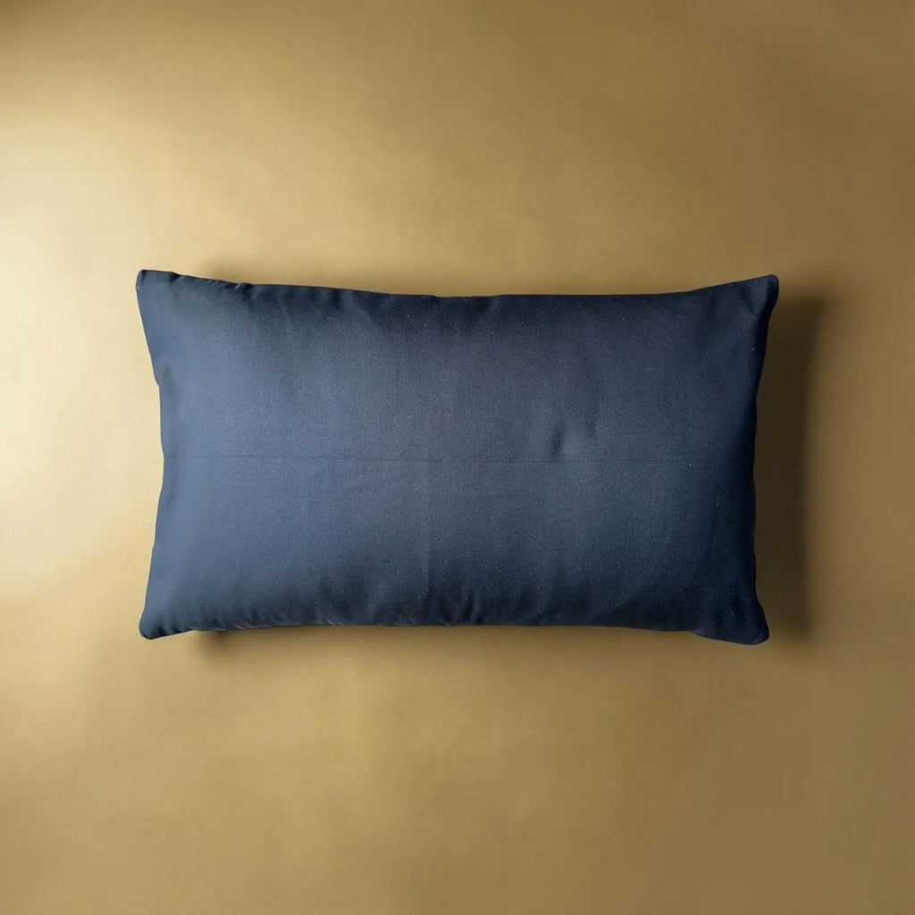 Black pillow on a beige background