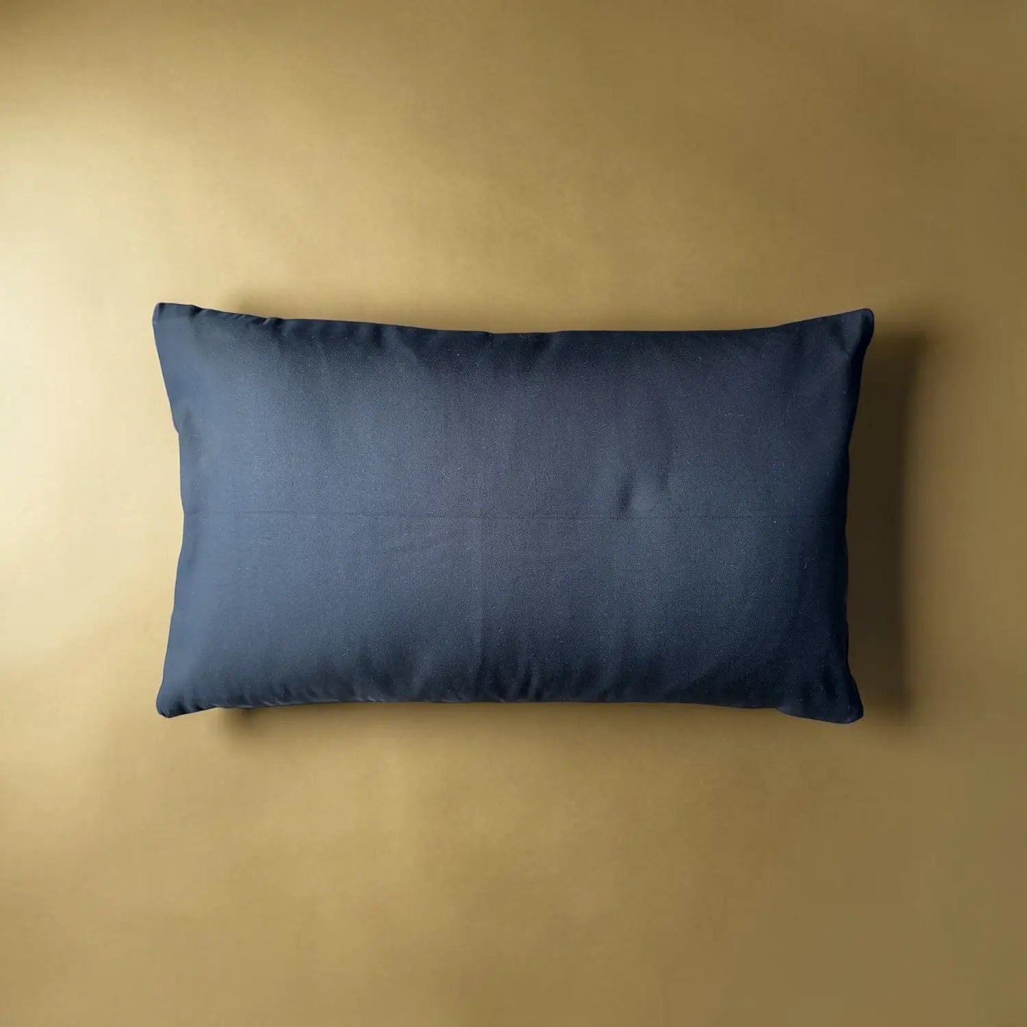 Black pillow on a beige background