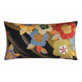 A rectangular decorative cushion featuring a floral pattern on a black silk-like fabric with gold.