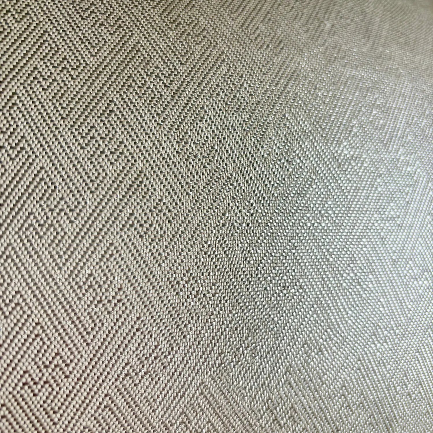 Close-up of a textured fabric with a herringbone pattern.