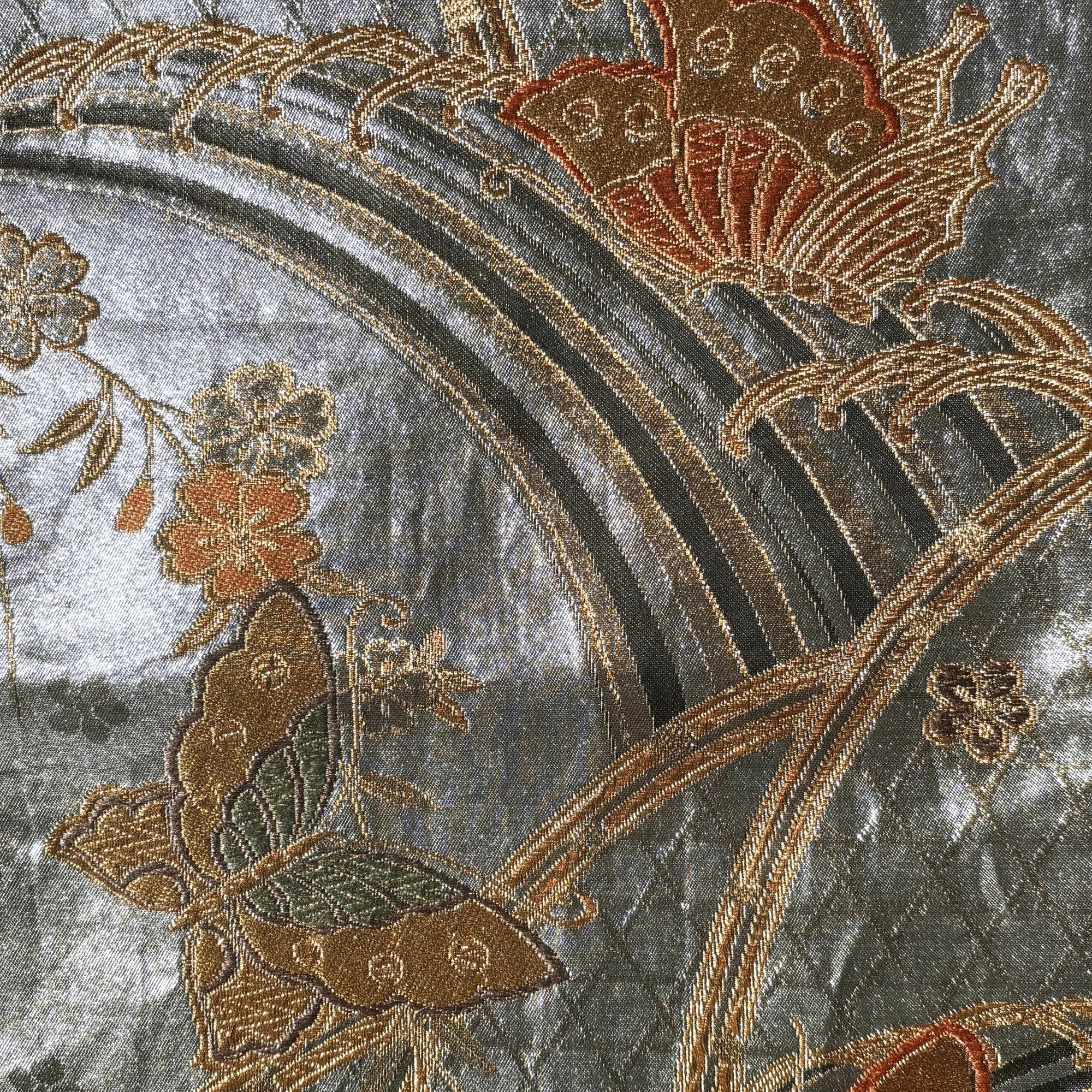 Close-up of embroidered fabric with butterflies and flowers on a textured background