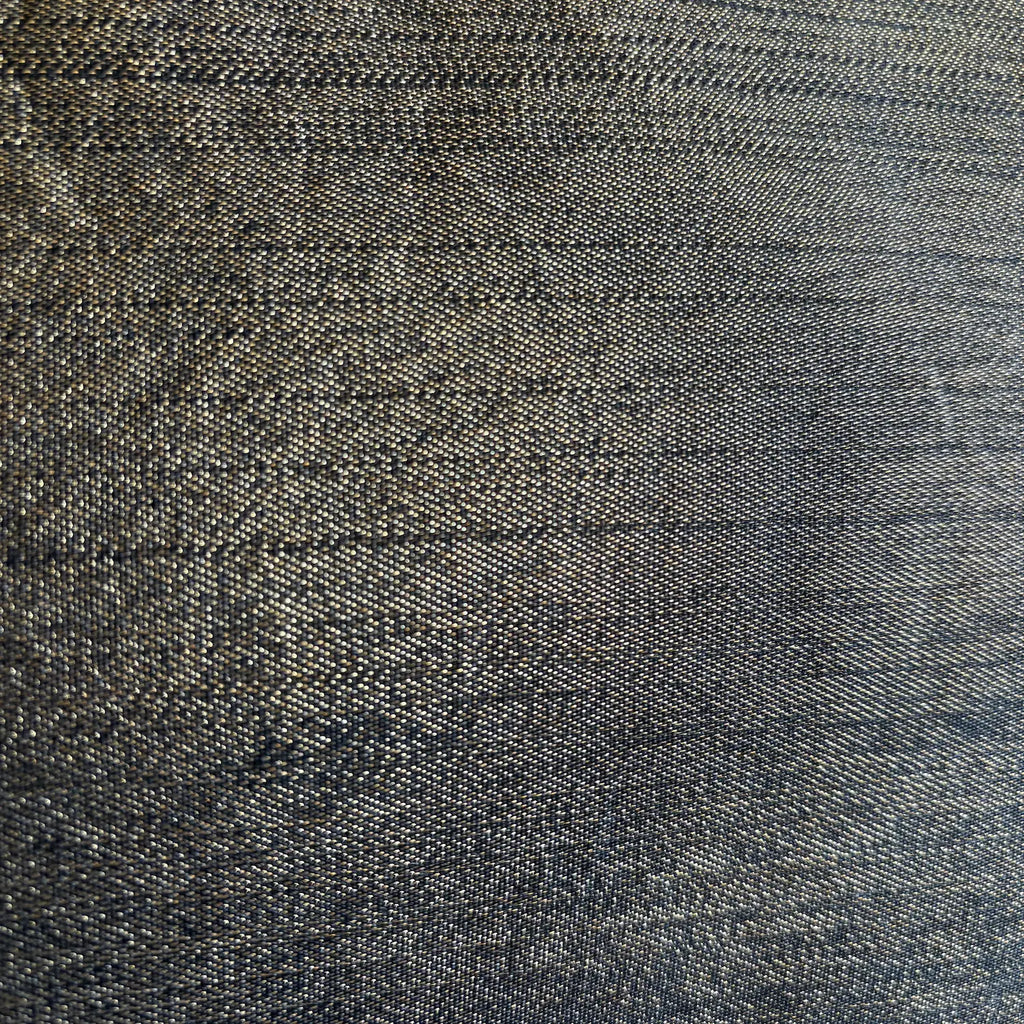Close-up of textured dark gold fabric with a subtle pattern