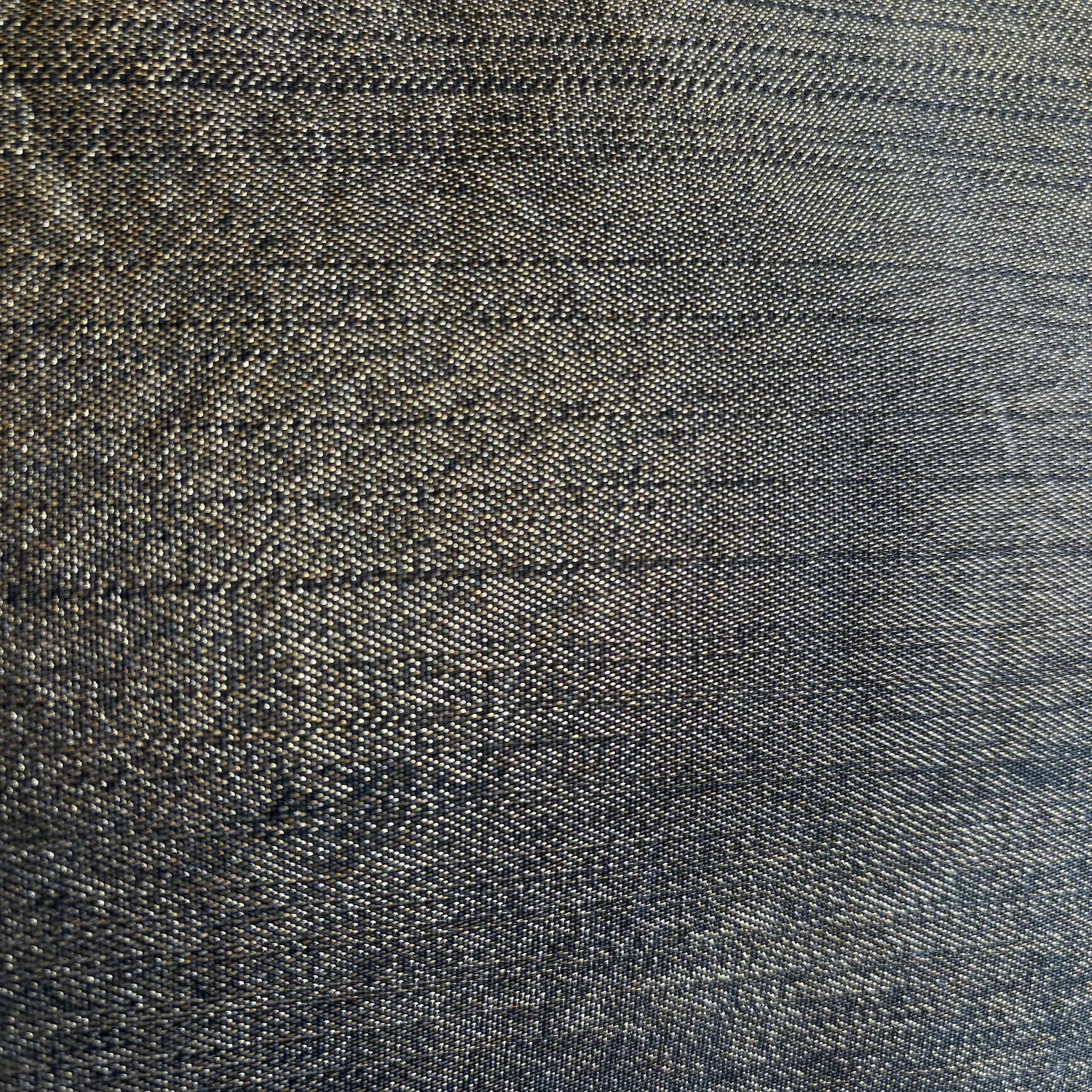 Close-up of textured dark gold fabric with a subtle pattern