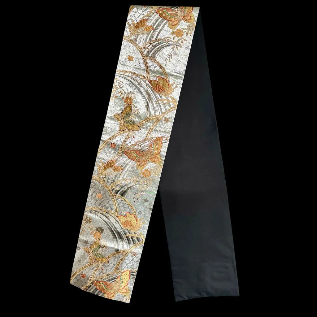 Decorative table runner with floral and architectural design on a black background