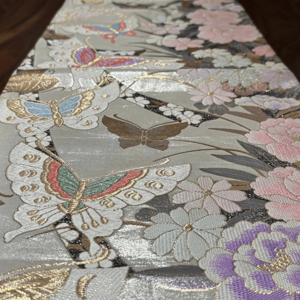 Close-up of a fabric with butterfly and floral patterns