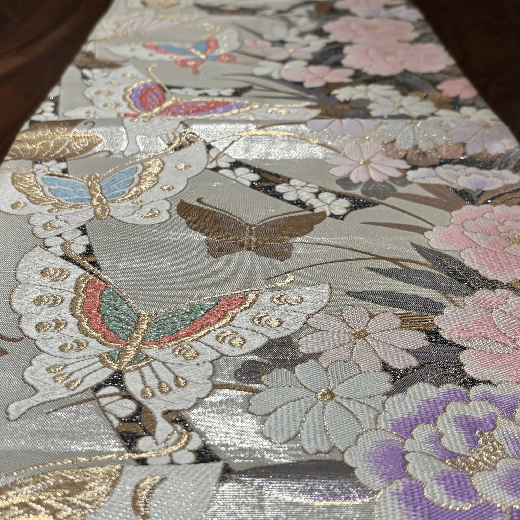Close-up of a fabric with butterfly and floral patterns